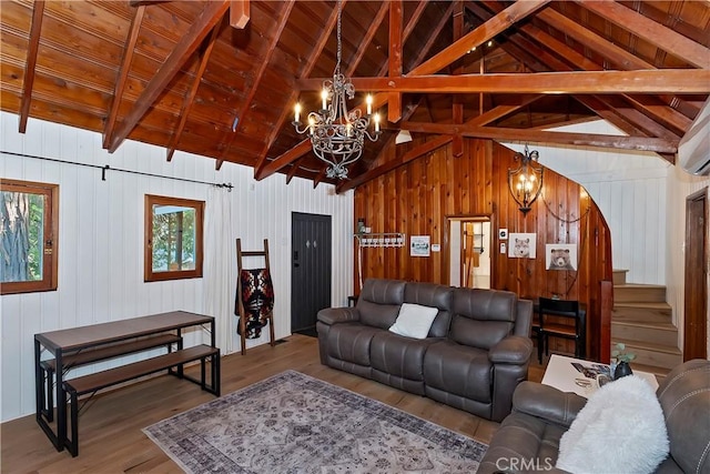 living room featuring wood-type flooring, lofted ceiling with beams, wooden ceiling, and a chandelier