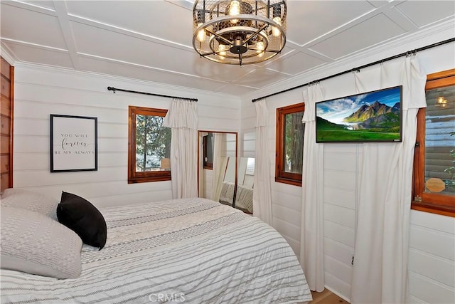 bedroom with coffered ceiling and a chandelier