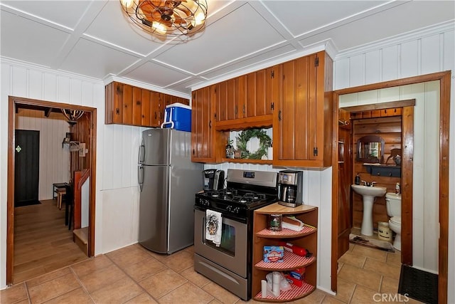 kitchen featuring appliances with stainless steel finishes, sink, and light tile patterned floors