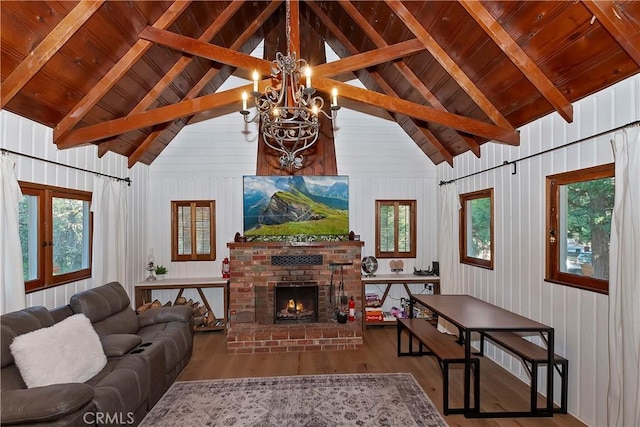 living room featuring wood ceiling, high vaulted ceiling, a brick fireplace, hardwood / wood-style flooring, and beam ceiling