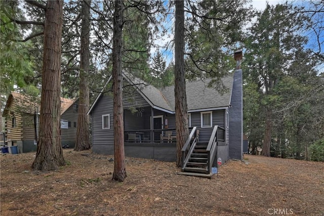 rear view of property featuring a sunroom