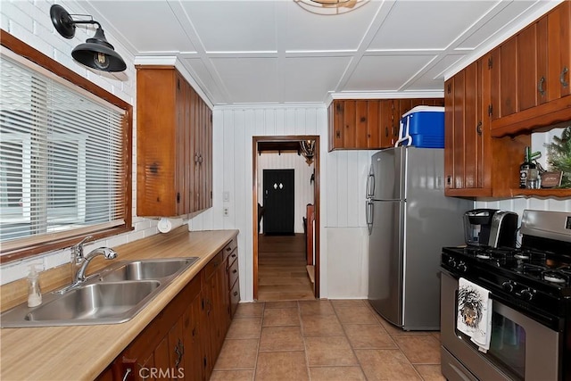 kitchen featuring sink, light tile patterned floors, and stainless steel appliances