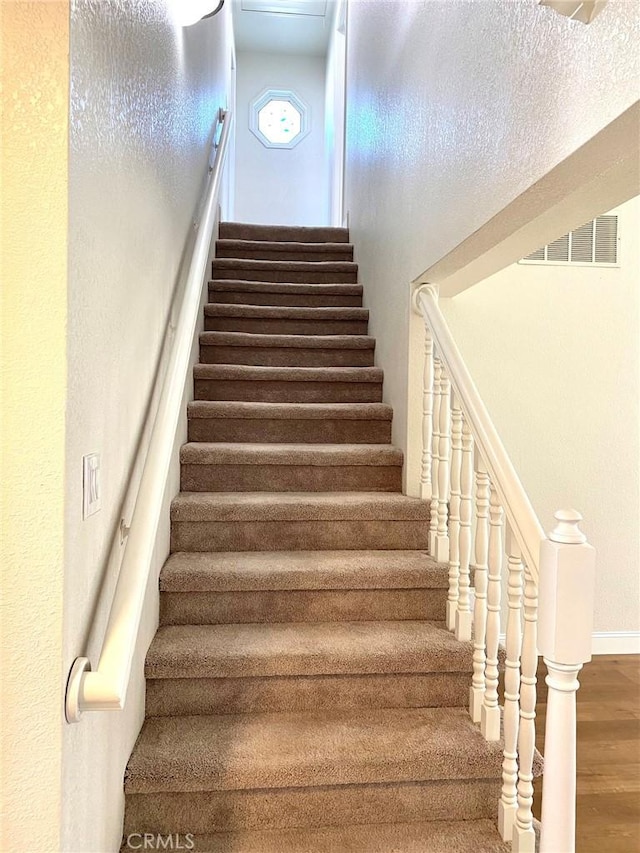 staircase featuring hardwood / wood-style floors