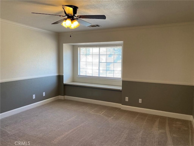 unfurnished room with ornamental molding, carpet, a textured ceiling, and ceiling fan