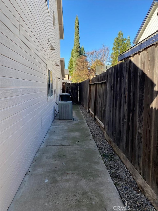 view of side of property with cooling unit and a patio area