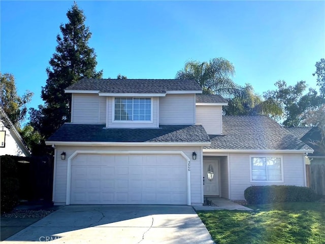 view of front property featuring a garage and a front yard