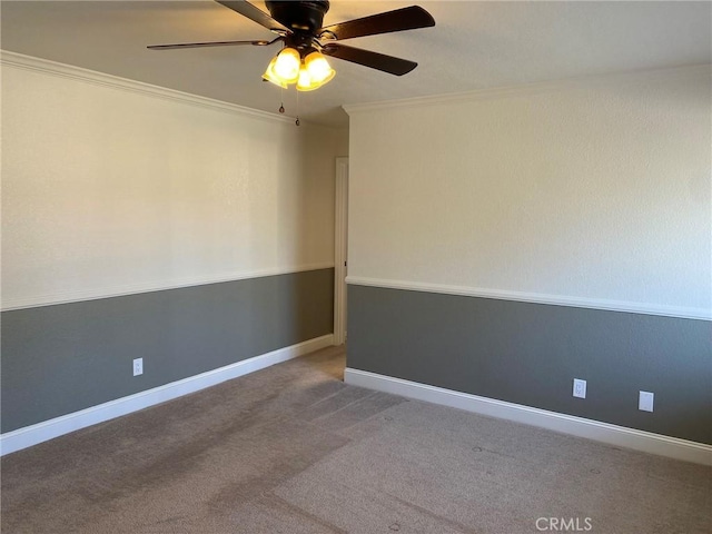 empty room with crown molding, ceiling fan, and carpet flooring