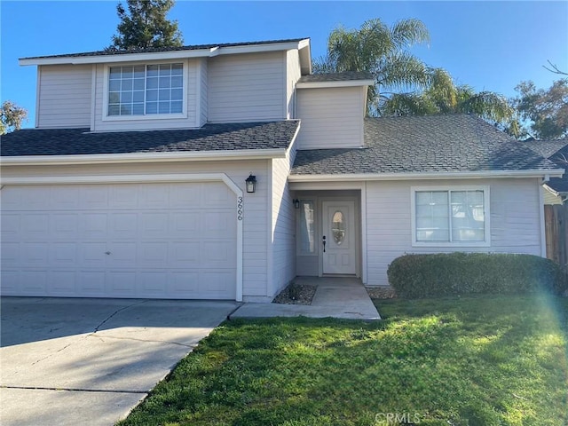 front of property featuring a garage and a front lawn