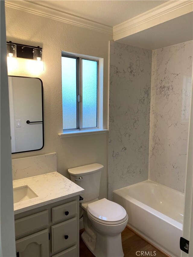 full bathroom featuring shower / washtub combination, hardwood / wood-style floors, vanity, ornamental molding, and toilet