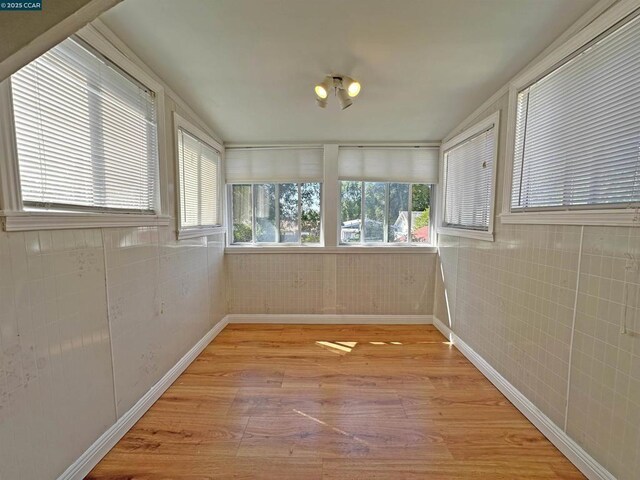 unfurnished sunroom with a healthy amount of sunlight