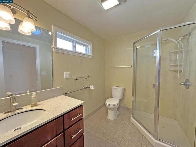 bathroom featuring walk in shower, vanity, and toilet