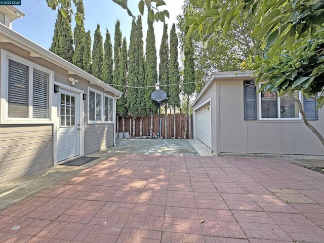 view of patio featuring an outbuilding and a garage