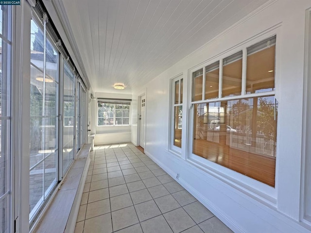 unfurnished sunroom with wooden ceiling