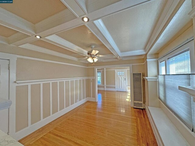 interior space with beamed ceiling, ceiling fan, and light hardwood / wood-style floors