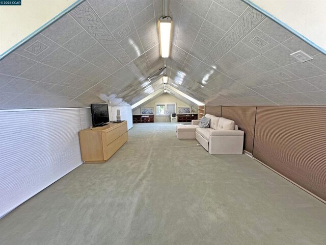 bonus room with carpet floors and vaulted ceiling