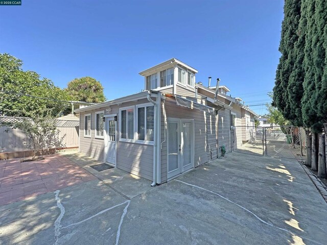 view of side of property with a patio