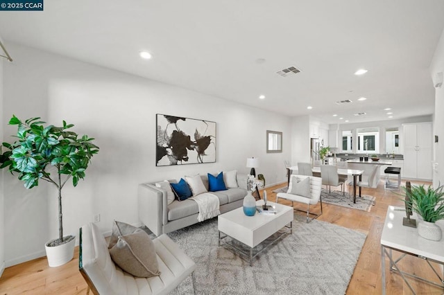 living room with light hardwood / wood-style flooring