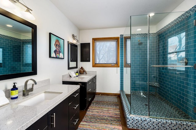 bathroom featuring a shower with door, vanity, and tile patterned flooring