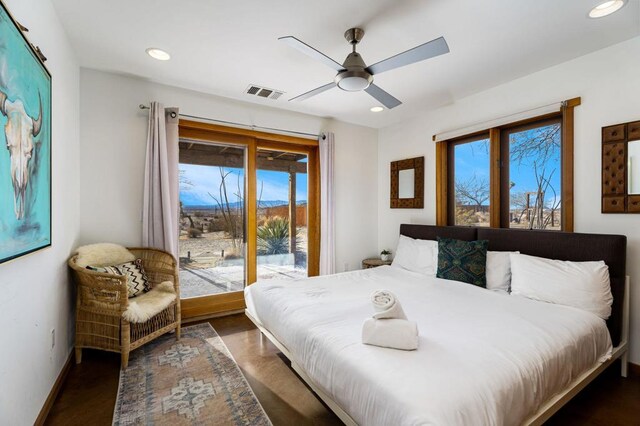 bedroom with ceiling fan, dark hardwood / wood-style flooring, and access to outside