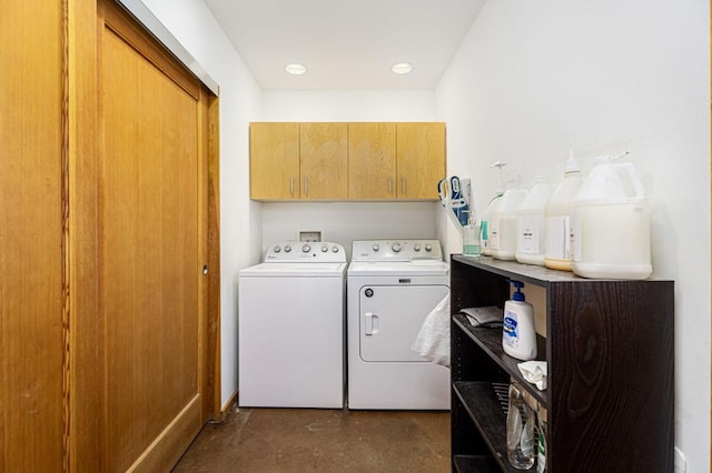 washroom with cabinets and washing machine and clothes dryer