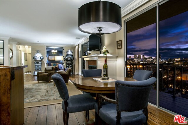 dining room featuring hardwood / wood-style flooring and ornamental molding