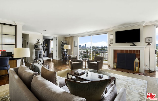 living room with hardwood / wood-style floors, a fireplace, and ornamental molding