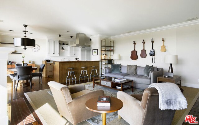 living room featuring dark hardwood / wood-style flooring and ornamental molding