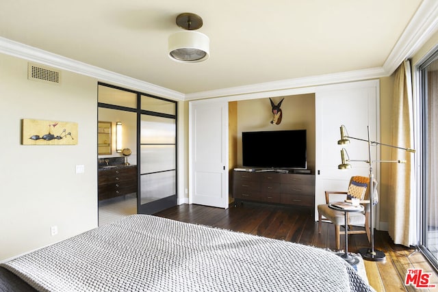 bedroom with crown molding and dark wood-type flooring