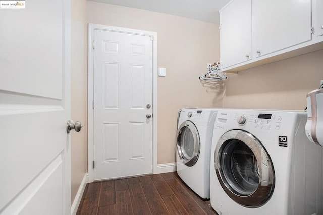 laundry area with dark wood-type flooring, cabinets, and washing machine and clothes dryer