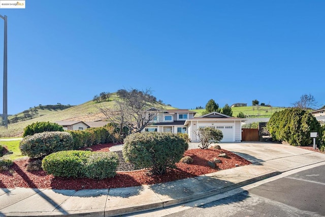 view of front of home with a garage and a mountain view