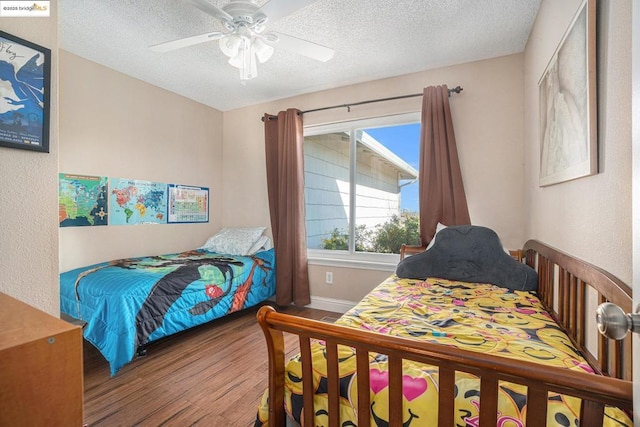 bedroom featuring wood-type flooring, ceiling fan, and a textured ceiling