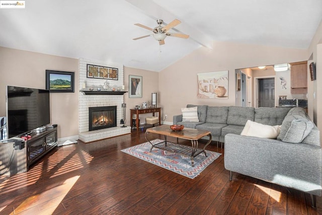 living room with a brick fireplace, hardwood / wood-style flooring, lofted ceiling with beams, and ceiling fan