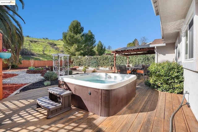 deck with a gazebo and a hot tub