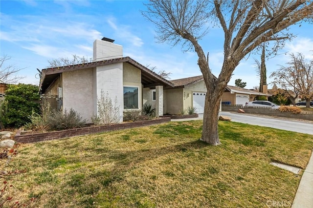 single story home featuring a garage and a front yard