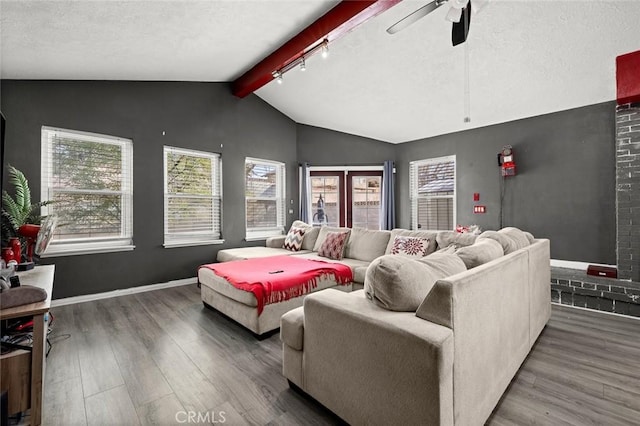 living room with ceiling fan, dark hardwood / wood-style floors, lofted ceiling with beams, and a textured ceiling