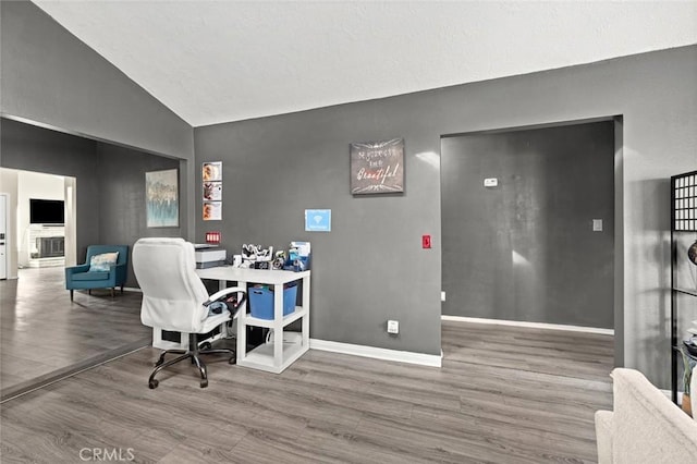 office space featuring hardwood / wood-style flooring and lofted ceiling