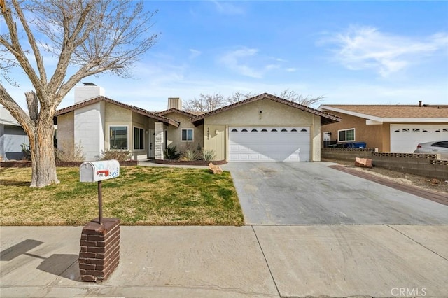 single story home featuring a garage and a front lawn