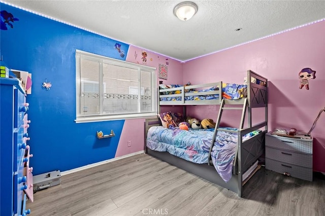 bedroom featuring wood-type flooring and a textured ceiling