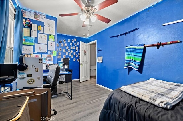 bedroom featuring hardwood / wood-style floors and ceiling fan