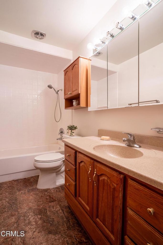 full bathroom featuring vanity, toilet, and tiled shower / bath