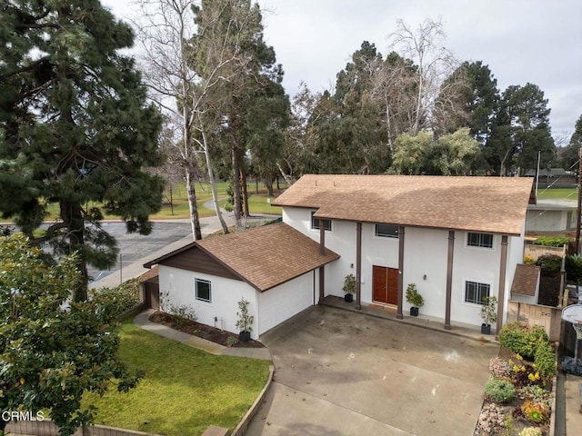 exterior space featuring a garage and a front lawn