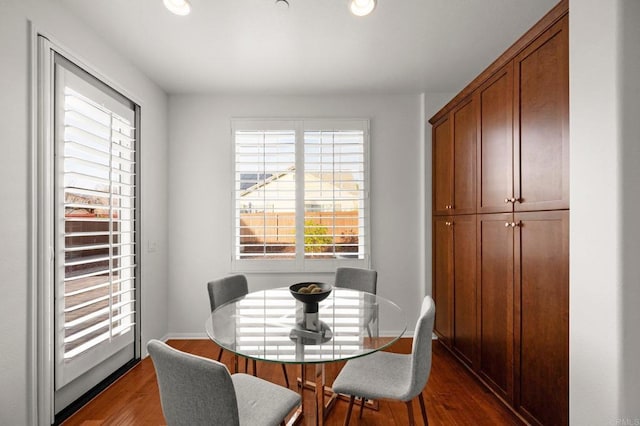 dining space with dark wood-type flooring