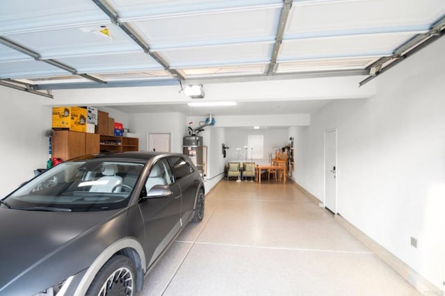 garage featuring a garage door opener and secured water heater