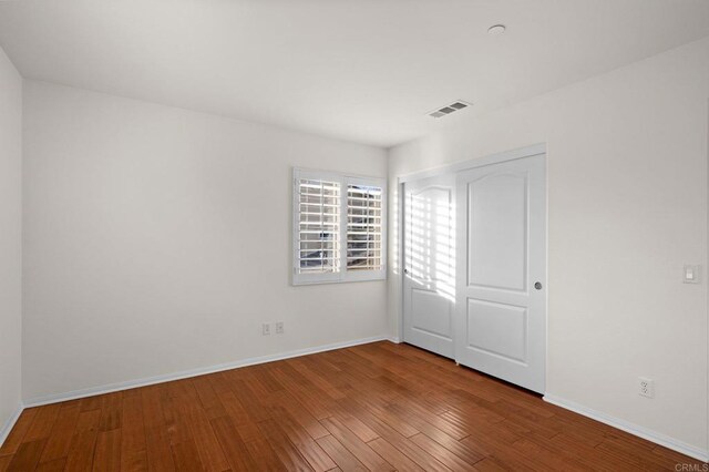 empty room with wood-type flooring