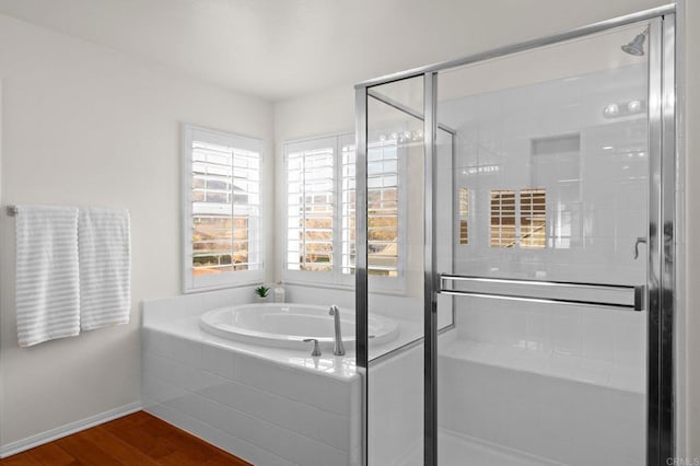 bathroom featuring hardwood / wood-style floors and shower with separate bathtub