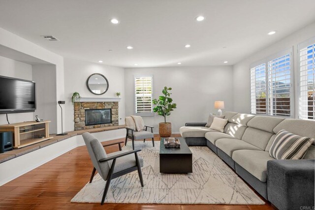 living room with a fireplace and light hardwood / wood-style floors