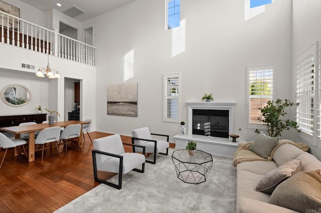 living room with wood-type flooring and a notable chandelier