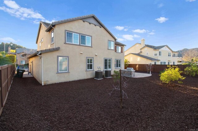 back of property featuring cooling unit and a patio area