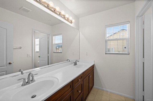 bathroom featuring tile patterned flooring and vanity