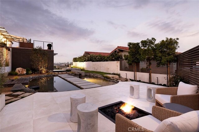 patio terrace at dusk with a fire pit